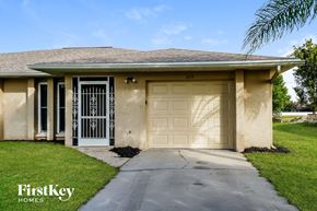 Cape Coral house for rent - a beige house with a white garage door