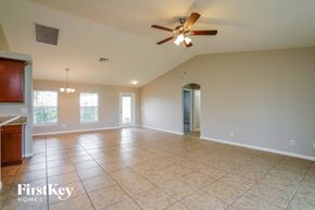 Cape Coral house for rent - A spacious room with a ceiling fan and tiled flooring.