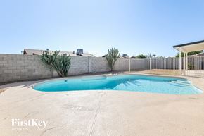 Phoenix house for rent - A small pool in a backyard with a Firstkey Homes logo.