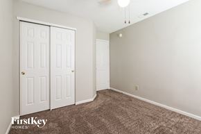 Indianapolis house for rent - a bedroom with a carpeted floor and two closet doors