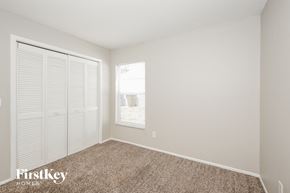Ocoee house for rent - a bedroom with white walls and a window and a closet