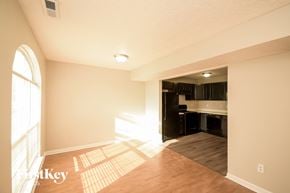 Indianapolis house for rent - A sunny room with a kitchen in the background.