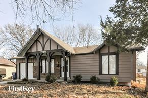 Florissant house for rent - A house with a brown facade and a large front porch.