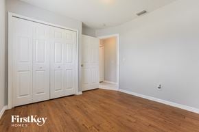 North Port house for rent - a bedroom with two closets and a hard wood floor