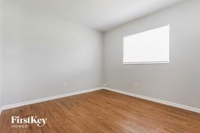 North Port house for rent - the living room with wood flooring and a window
