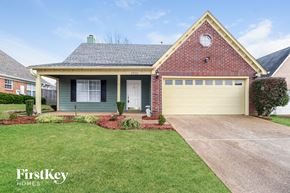Cordova house for rent - A house with a garage and a driveway in front of it.