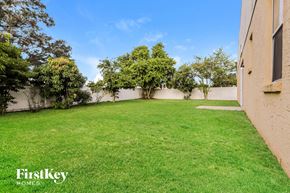 Lakeland house for rent - A backyard with a well-maintained lawn and trees.