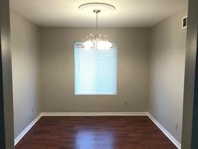 Fairfield house for rent - an empty dining room with a window and a chandelier