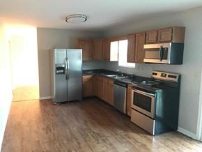 Fairfield house for rent - an empty kitchen with stainless steel appliances and wooden floors