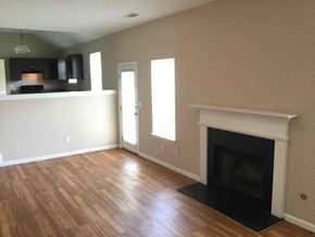 Ellenwood house for rent - a living room with a fireplace and wooden floors