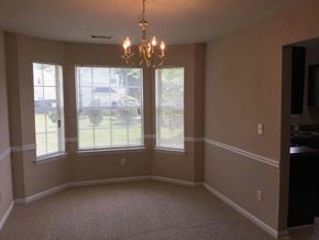 Ellenwood house for rent - an empty dining room with windows and a chandelier
