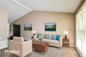 Florissant house for rent - A living room with a couch, chair, and coffee table.