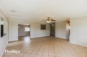 Homestead house for rent - an empty living room with tile flooring and a ceiling fan