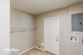 Homestead house for rent - a bedroom with a closet and a white door and a hanging rack on the wall