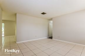Deltona house for rent - A spacious room with white walls and tiled floor.