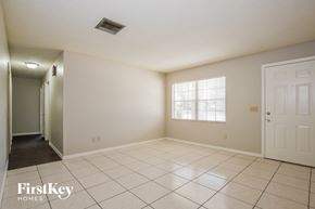Deltona house for rent - A spacious room with a tiled floor and a window letting in natural light.