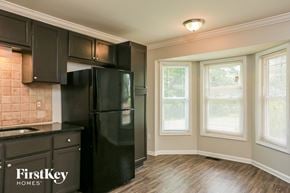 Austell house for rent - a kitchen with black appliances and a large window