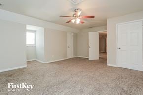Austell house for rent - a master bedroom with carpet and a ceiling fan