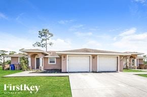 Lehigh Acres house for rent - A house with a clear blue sky and a tree in front of it.