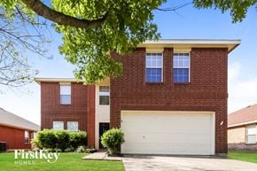Royse City house for rent - a red brick house with a white garage door