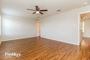 Royse City house for rent - a living room with wood flooring and a ceiling fan