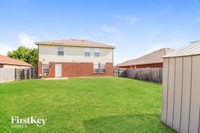 Royse City house for rent - a backyard with a house and a grass lawn