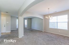 Richmond house for rent - an empty living room with a chandelier and a large window