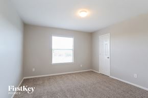 Richmond house for rent - a bedroom with carpet and a window and a white door