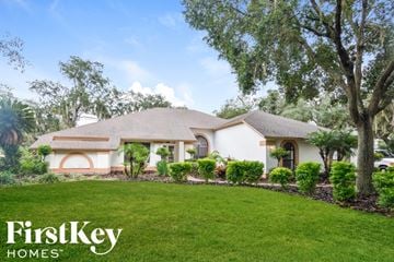 Plant City house for rent - a home with a lawn and trees in front of it