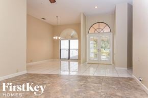 Plant City house for rent - an empty living room with a large tile floor and a glass door