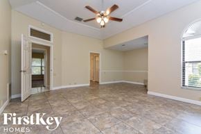 Plant City house for rent - an empty living room with a ceiling fan and a tile floor