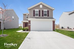 Indianapolis house for rent - a house with a white driveway in front of a lawn