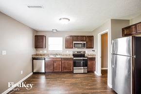 Indianapolis house for rent - a kitchen with stainless steel appliances and wooden cabinets