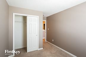 Indianapolis house for rent - a bedroom with a closet and a white door