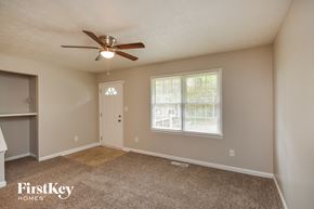 Conyers house for rent - an empty room with a ceiling fan and a window