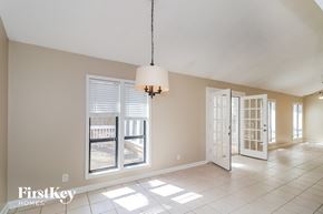 Marietta house for rent - a dining room with a door to a balcony and a chandelier