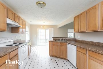 Raleigh house for rent - A kitchen with wooden cabinets and a white dishwasher.