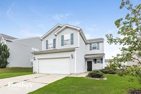 Raleigh house for rent - a white house with white siding and a green lawn