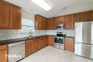 Middleburg house for rent - a kitchen with wooden cabinets and stainless steel appliances