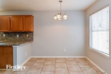 Spring house for rent - a kitchen with tiled flooring and a granite counter top
