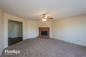 Lancaster house for rent - A spacious living room with a fireplace and a ceiling fan.