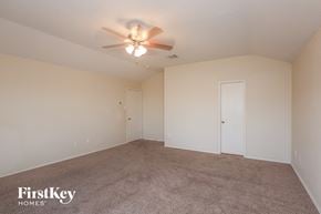 Lancaster house for rent - A spacious room with a ceiling fan and two doors.