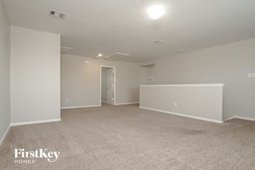 Katy house for rent - a spacious living room with carpet and white walls