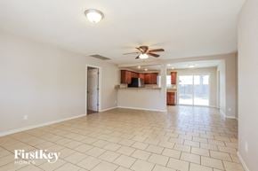 Phoenix house for rent - A spacious living room with a fan and tiled flooring.