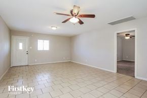 Phoenix house for rent - A spacious room with a ceiling fan and tiled flooring.