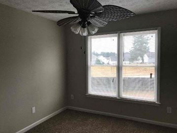 Lawrenceville house for rent - a living room with a ceiling fan and a window