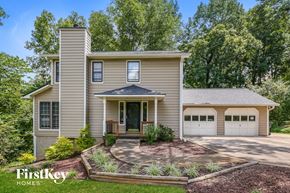 Marietta house for rent - a house with two garage doors and a driveway