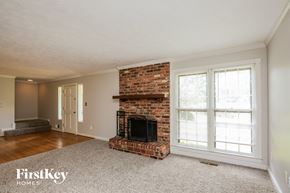 Marietta house for rent - a living room with a brick fireplace and a window