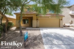 Queen Creek house for rent - a house with a garage door and a tree