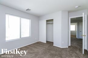 Queen Creek house for rent - a bedroom with white walls and carpet and a door to a closet